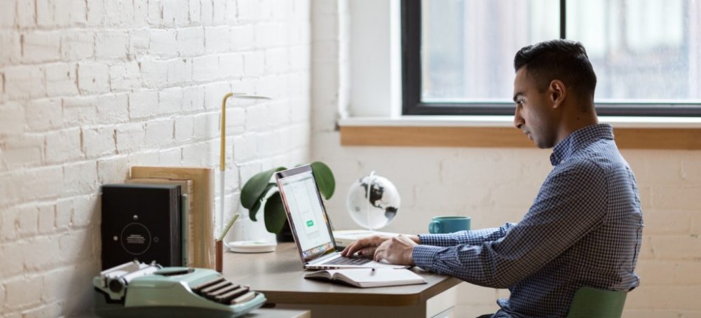 man-sitting-on-green-chair-while-using-laptop-374831-e1587048843193-1024x465
